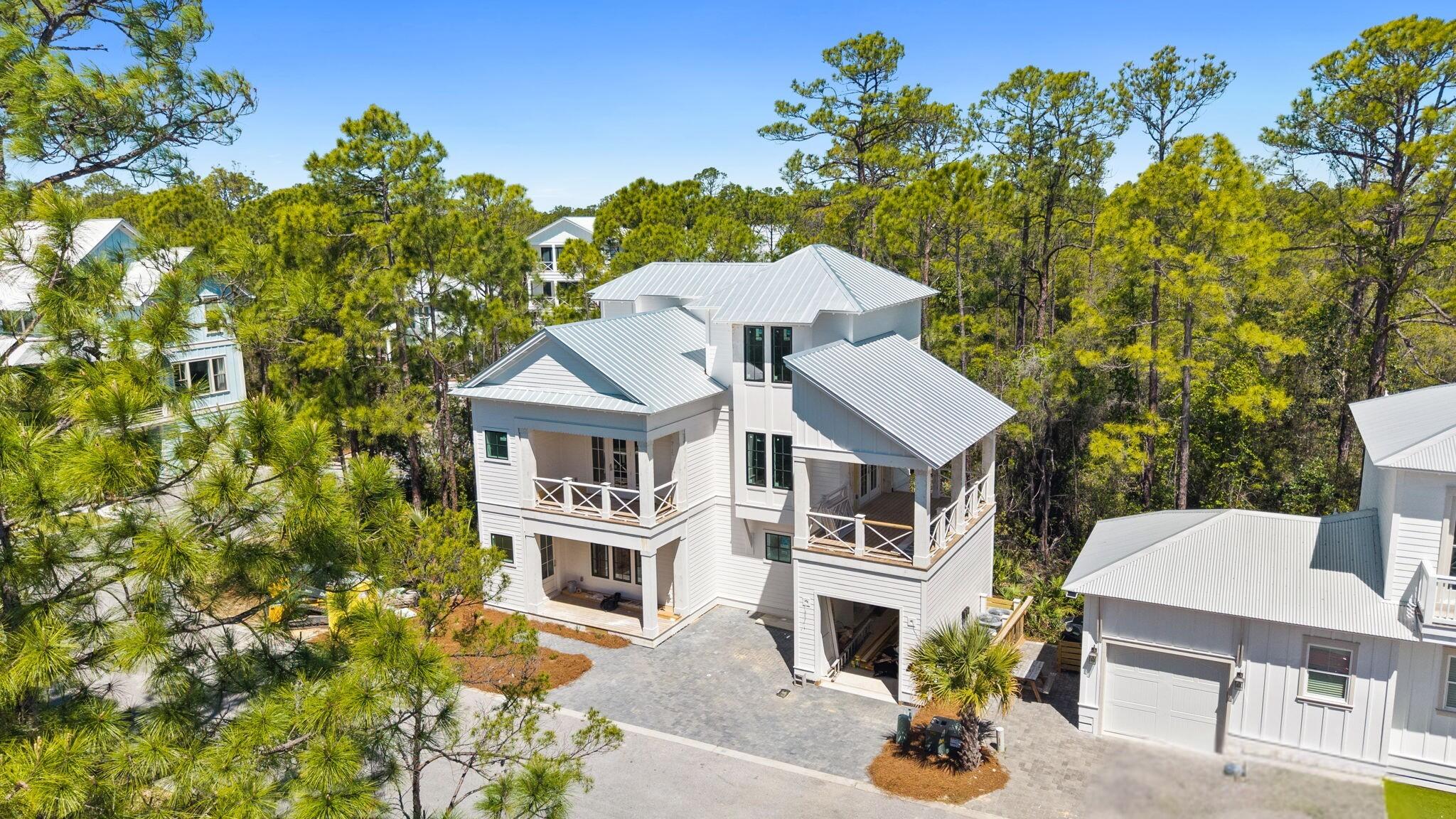 330 Redbud Ln Inlet Beach Inlet Beach, FL 32461 - Photo 1 of 16 a aerial view of a house with a large tree and a yard