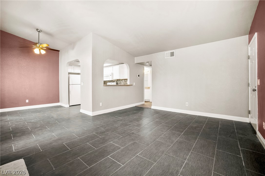 3311 Sunfish Drive, Unit D Henderson, NV 89014 - Photo 7 of 21 Discover an inviting open concept living space, featuring high vaulted ceilings and durable tile flooring throughout.