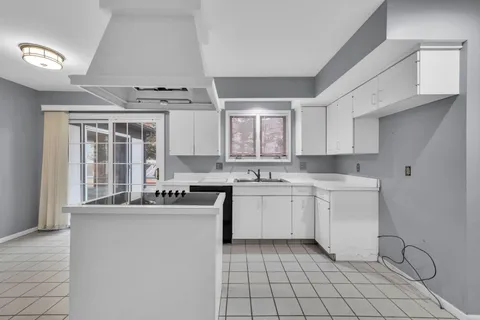 a view of an empty room with a fireplace and a window