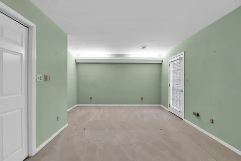 a view of an empty room with windows