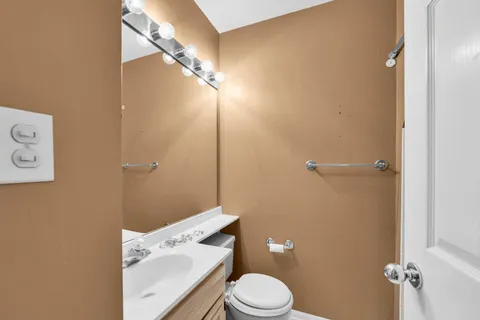 an empty room with windows and ceiling fan