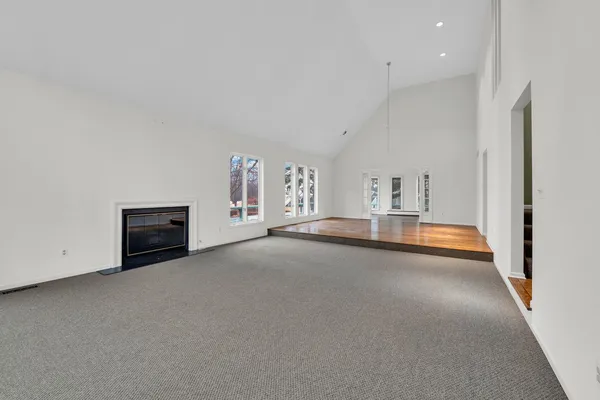a view of empty room with a fireplace