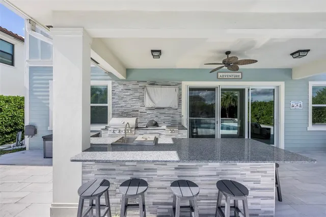 a living room with furniture a chandelier and a potted plant