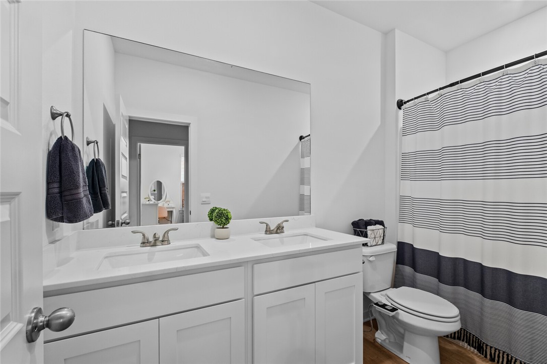 2105 Oliver Street Pea Ridge, AR 72751 - Photo 19 of 26 Dual vanity featuring white shaker cabinetry, integrated sinks, and brushed nickel fixtures