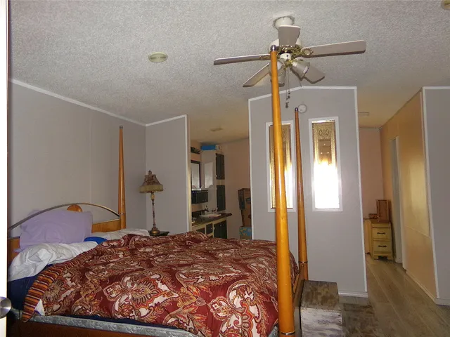 a bedroom with a bed and a chandelier