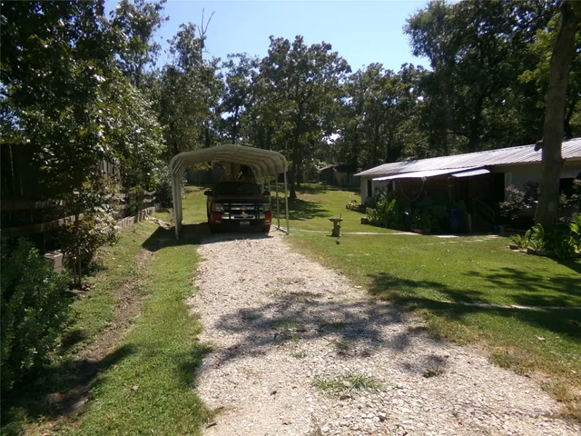 a view of a backyard with sitting area and garden