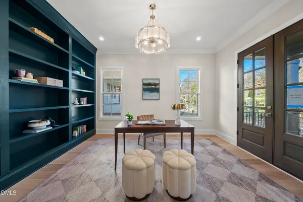 a dining table with chairs and kitchen view