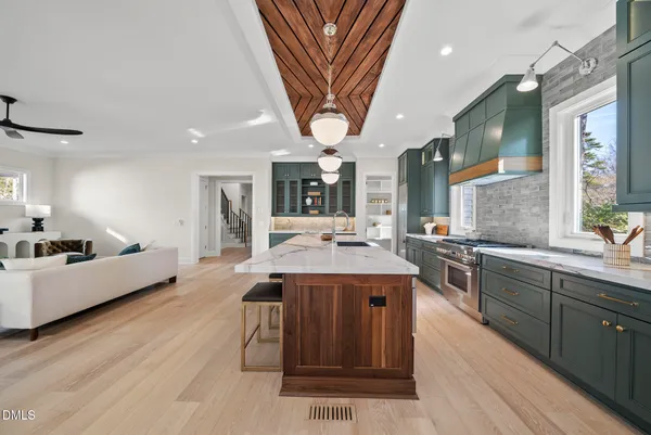 a stove top oven sitting inside of a kitchen