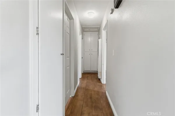 a view of a hallway with wooden floor