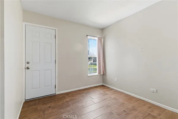 a view of a room with wooden floor and closet