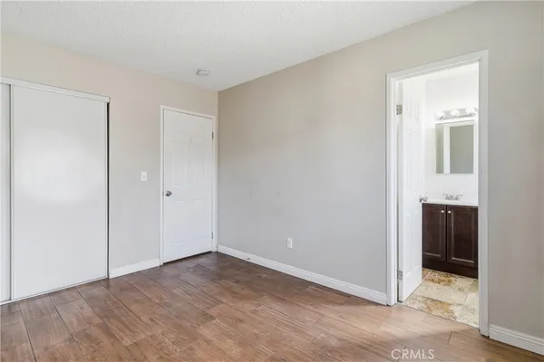 an empty room with an entryway and hallway