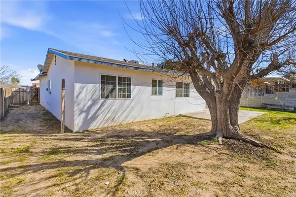 a view of backyard with wooden fence