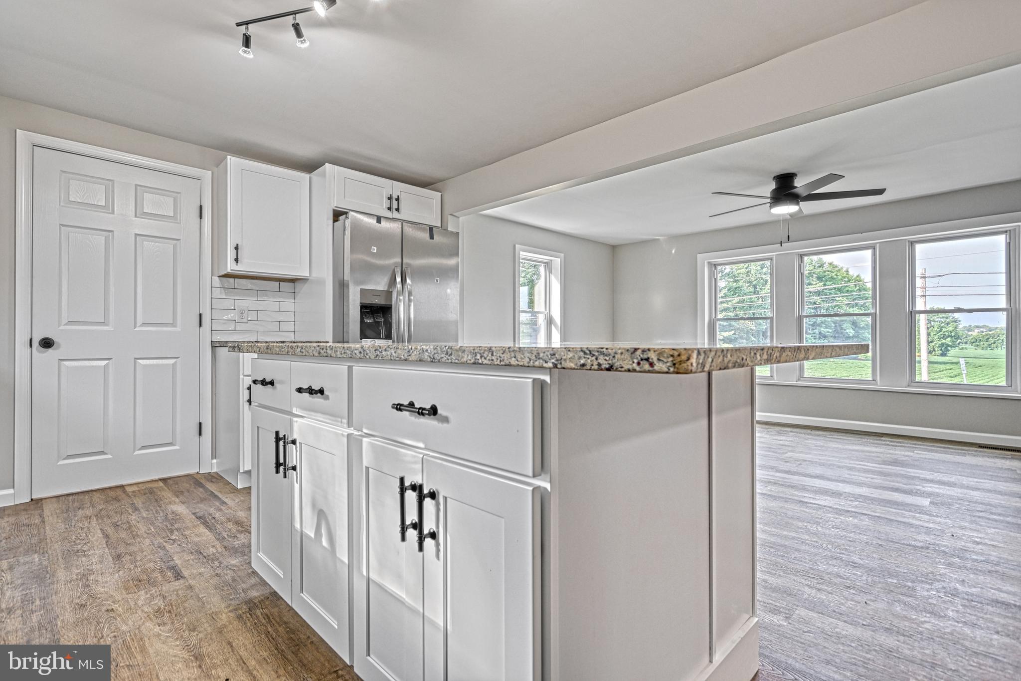 455 Petersburg Road Carlisle, PA 17015 - Photo 34 of 77 a large white kitchen with granite countertop a refrigerator and a stove