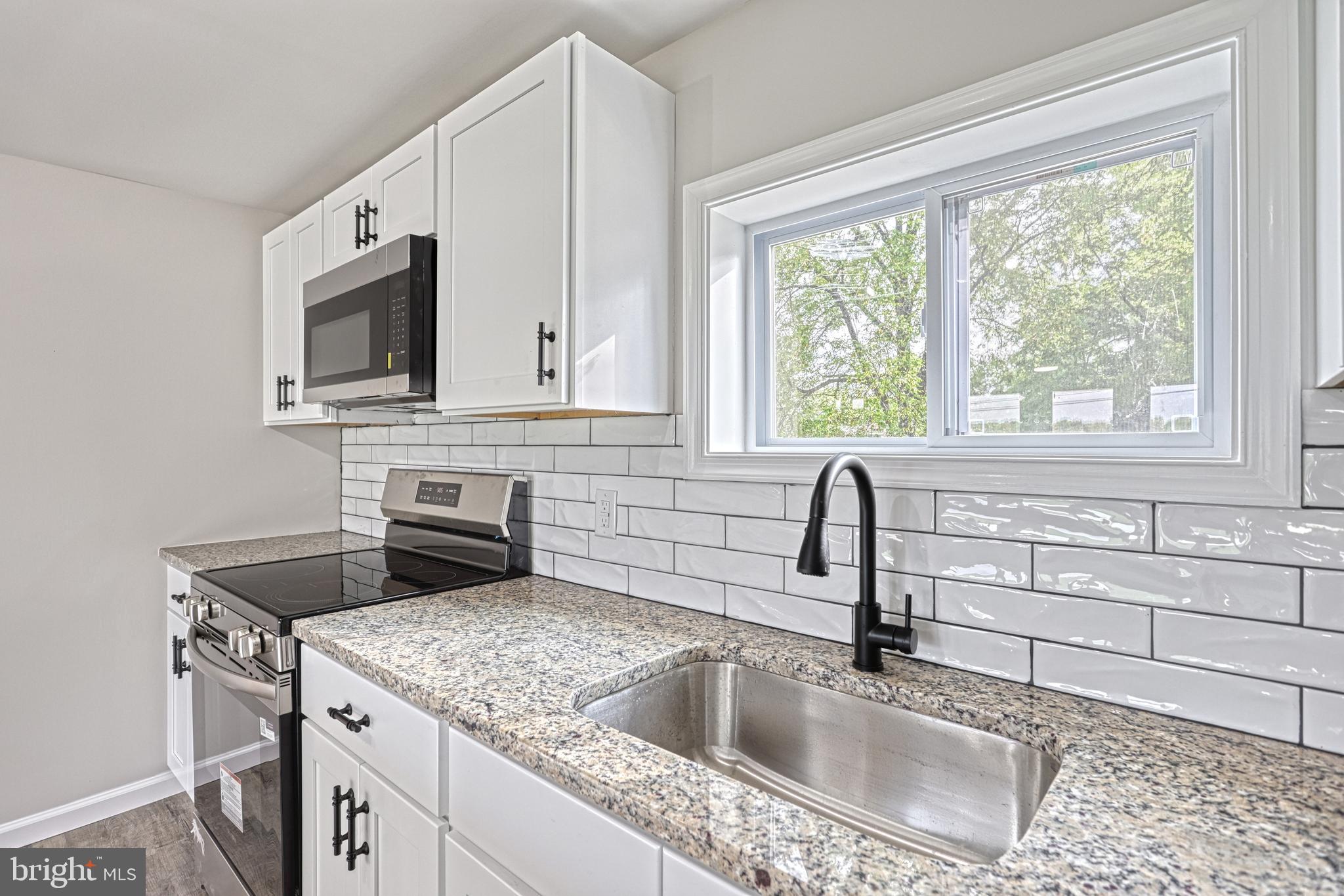 455 Petersburg Road Carlisle, PA 17015 - Photo 37 of 77 a kitchen with granite countertop a sink and a stove top oven