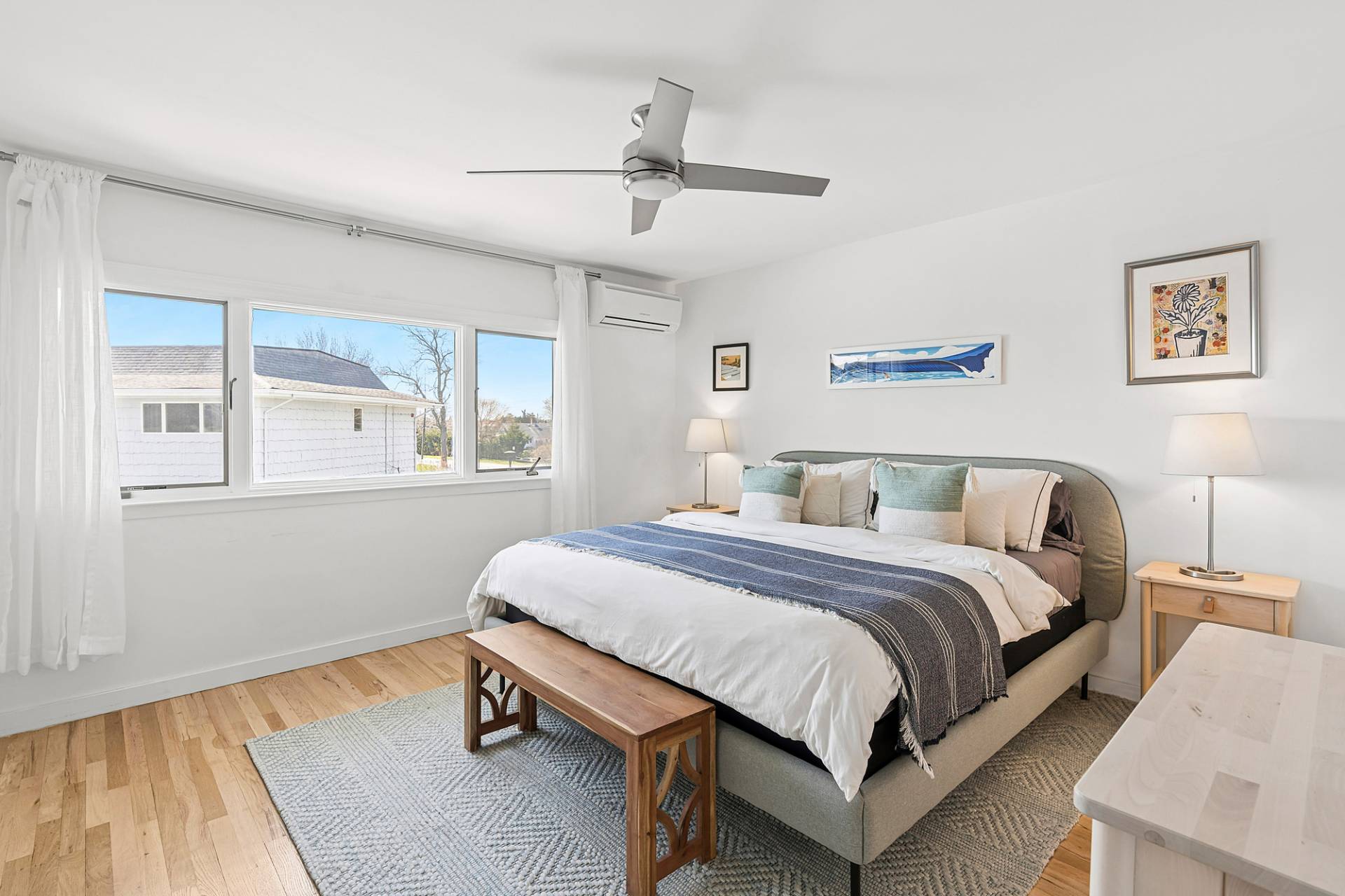 3004 Mitchell Road Westhampton Beach, NY 11978 - Photo 8 of 24 a bedroom with a bed wooden floor and window