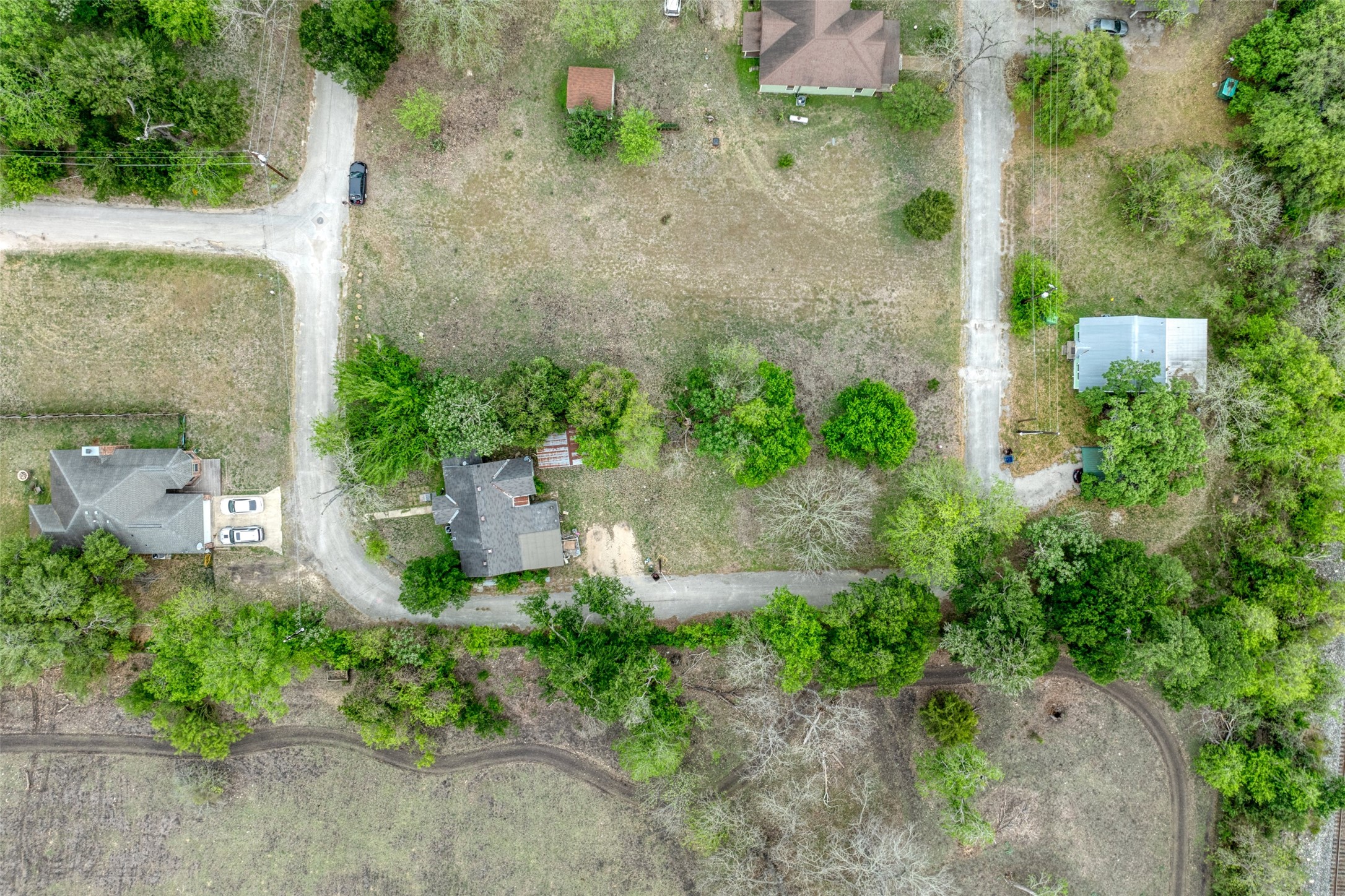 1002 Proctor Street Lockhart, TX 78644 - Photo 6 of 8 an aerial view of a house with a yard and greenery