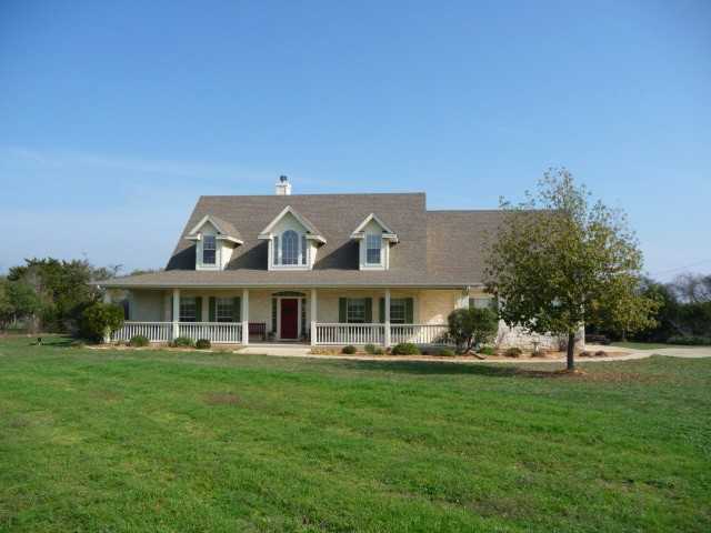 217 Skyline Road Georgetown, TX 78628 - Photo 1 of 1 a front view of a house with a garden and trees