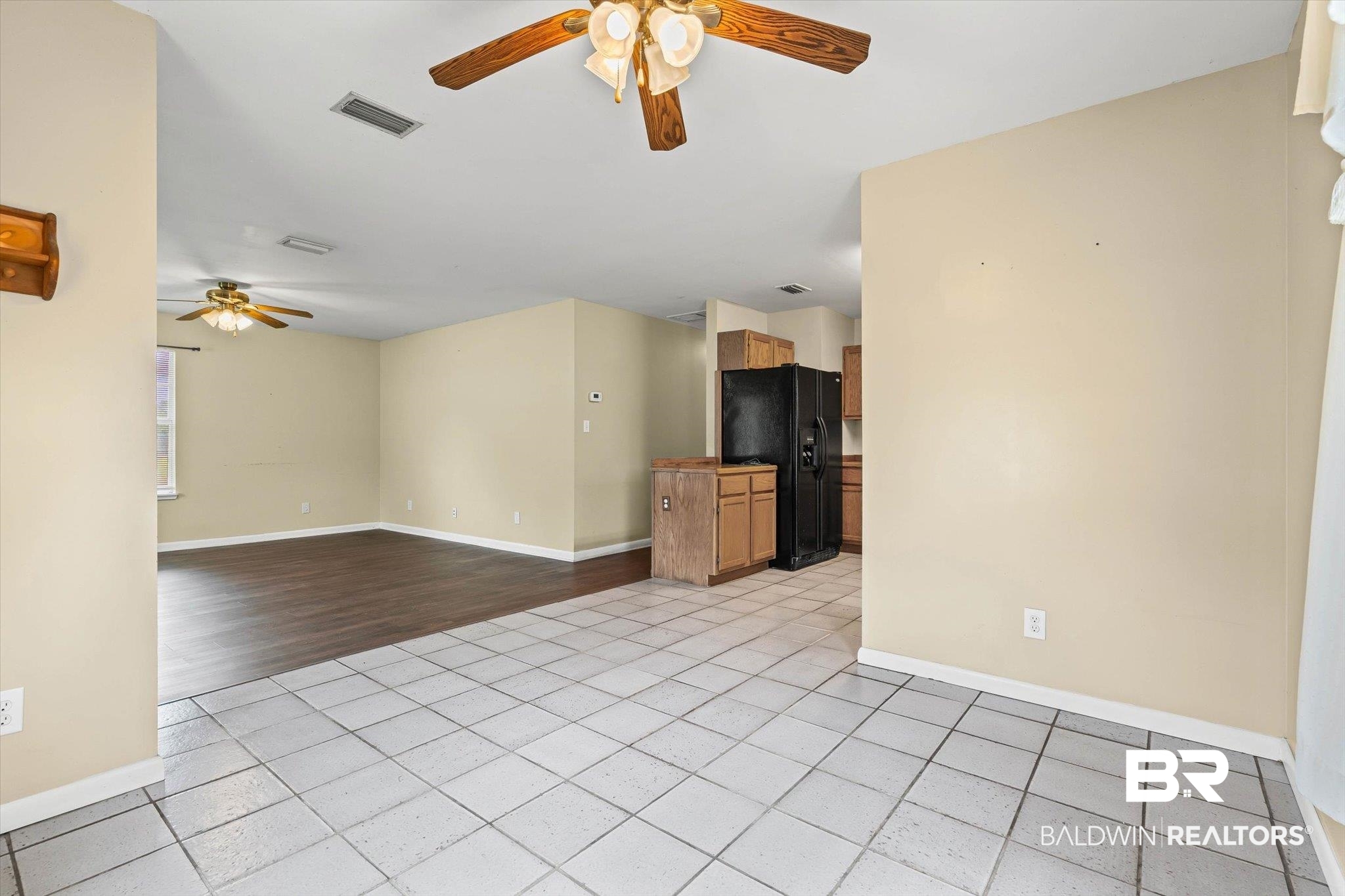 13908 White Road Silverhill, AL 36576 - Photo 10 of 23 Unfurnished living room with light tile patterned flooring and ceiling fan