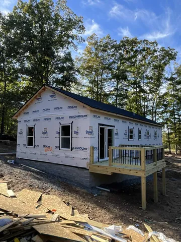 a view of house with yard and sitting area