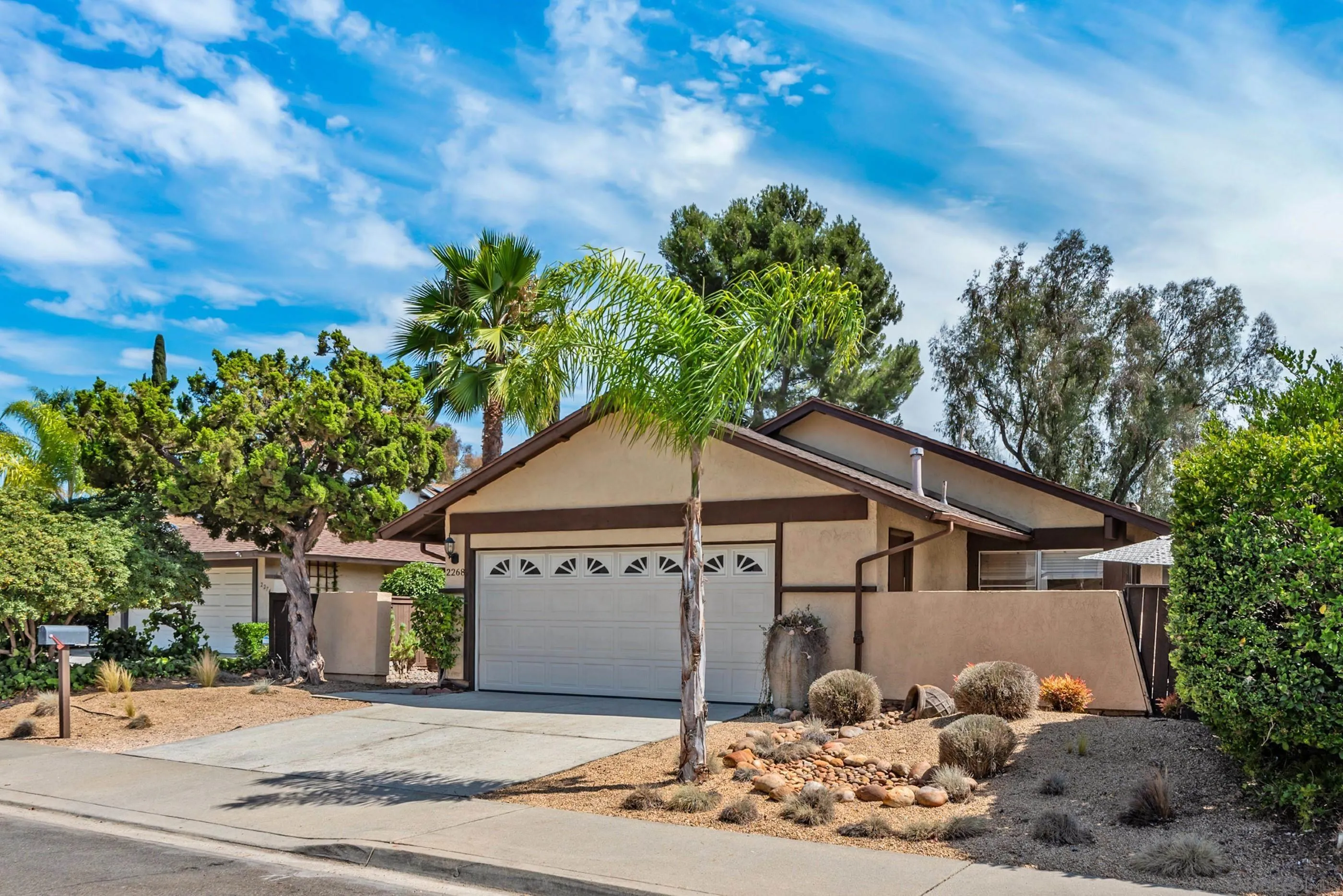 2268 Village Road Escondido, CA 92026 - Photo 1 of 43 a front view of a house with a yard and garage