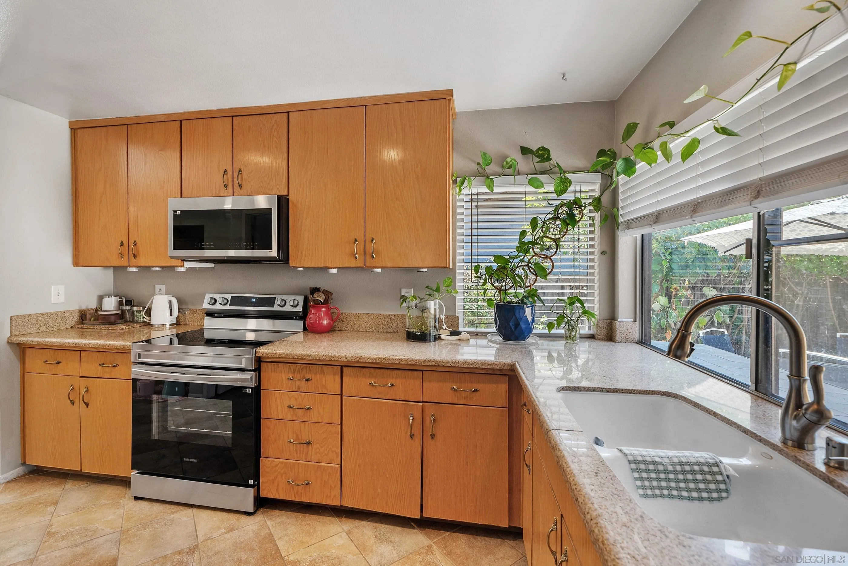 2268 Village Road Escondido, CA 92026 - Photo 14 of 43 a kitchen with a stove a sink and a microwave