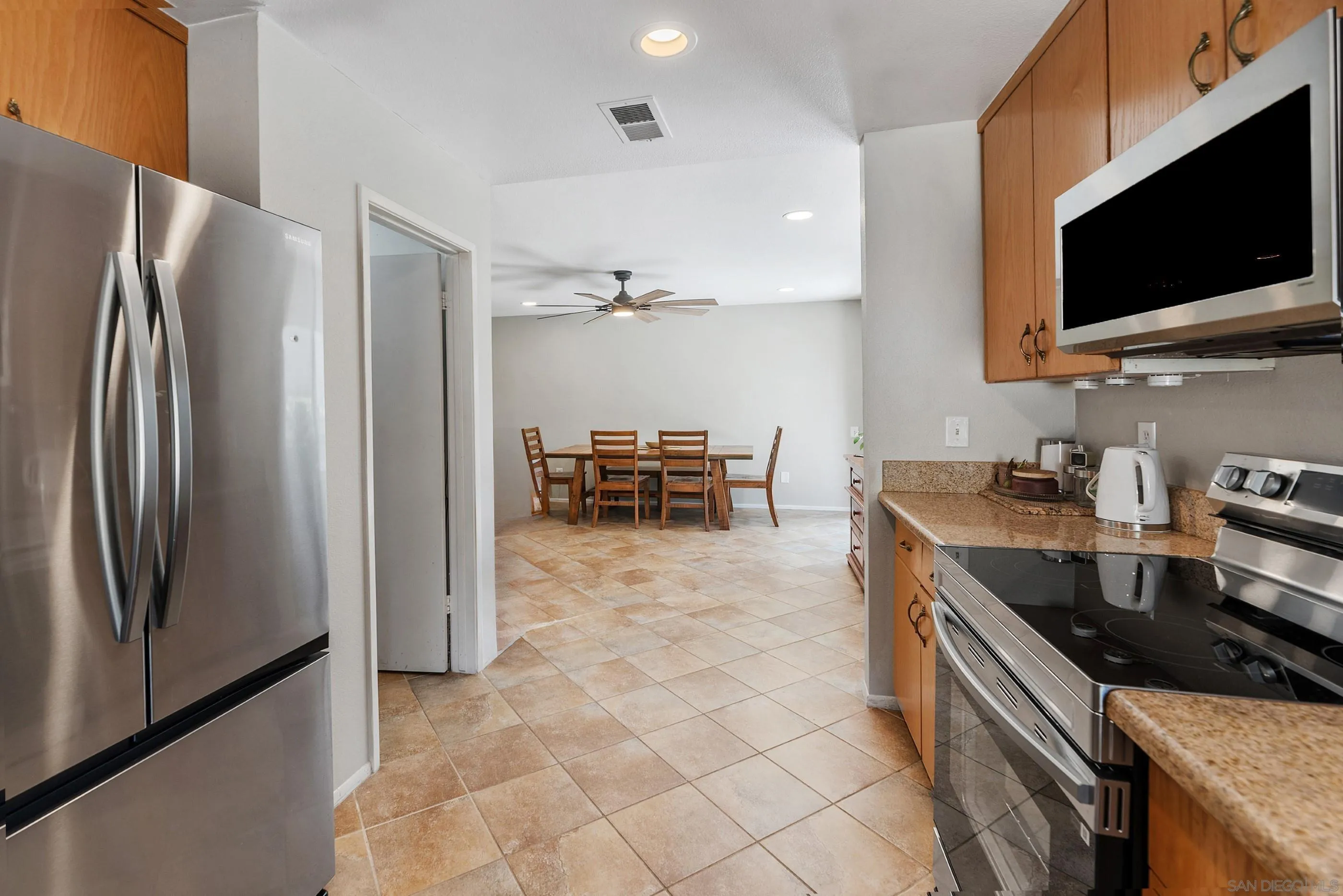 2268 Village Road Escondido, CA 92026 - Photo 15 of 43 a kitchen with stainless steel appliances granite countertop a refrigerator and a stove top oven