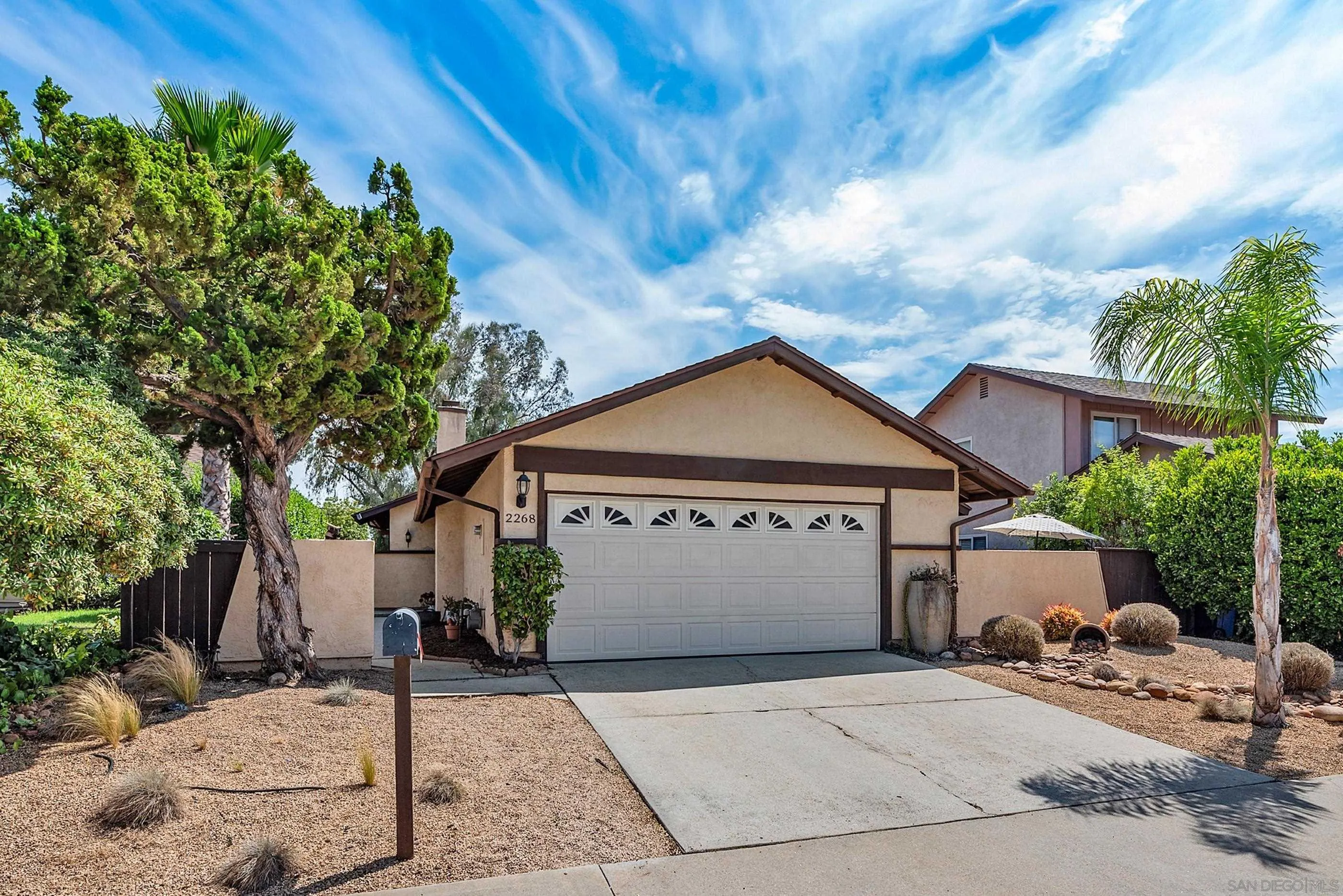 2268 Village Road Escondido, CA 92026 - Photo 2 of 43 a front view of a house with a garden