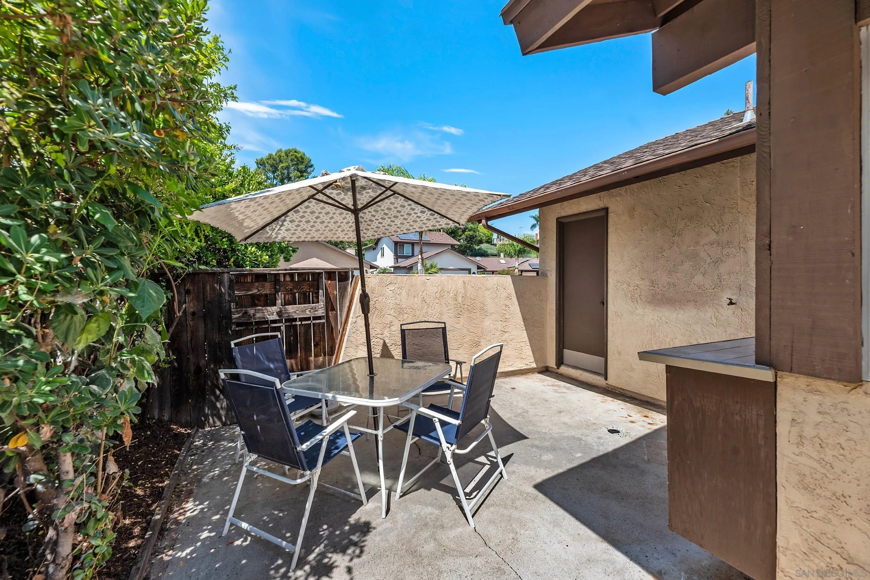 2268 Village Road Escondido, CA 92026 - Photo 26 of 43 a patio with a table and chairs under an umbrella