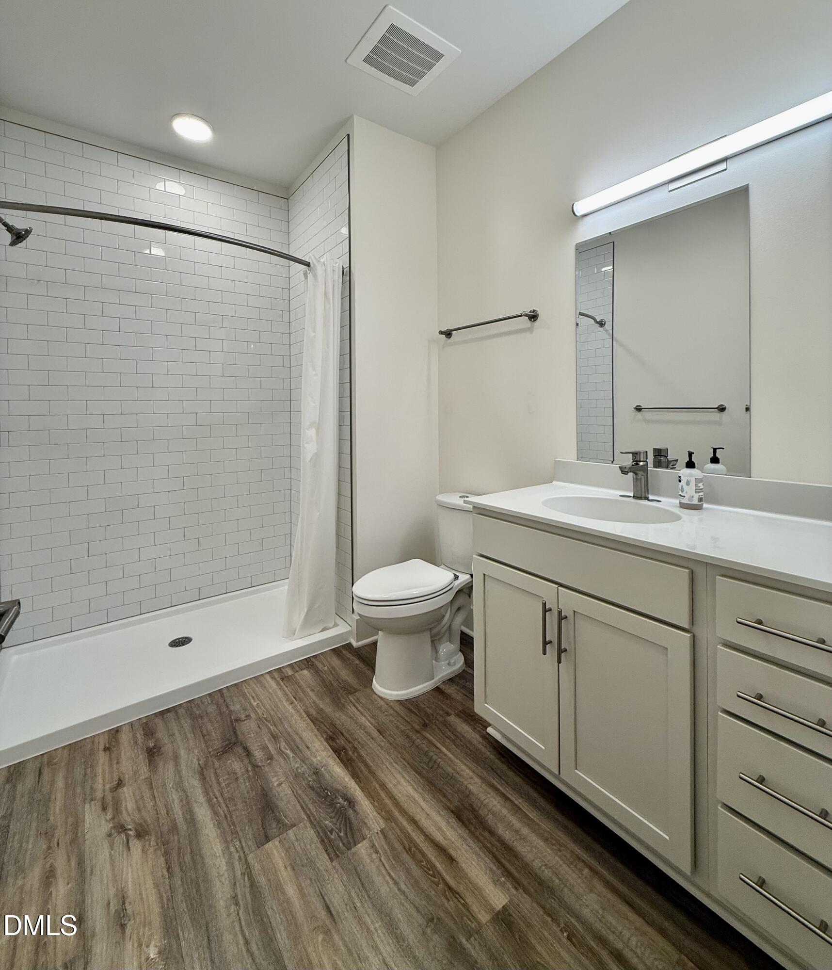 610 Trent Drive, Unit 403 Durham, NC 27705 - Photo 17 of 51 a bathroom with a double vanity sink toilet and shower