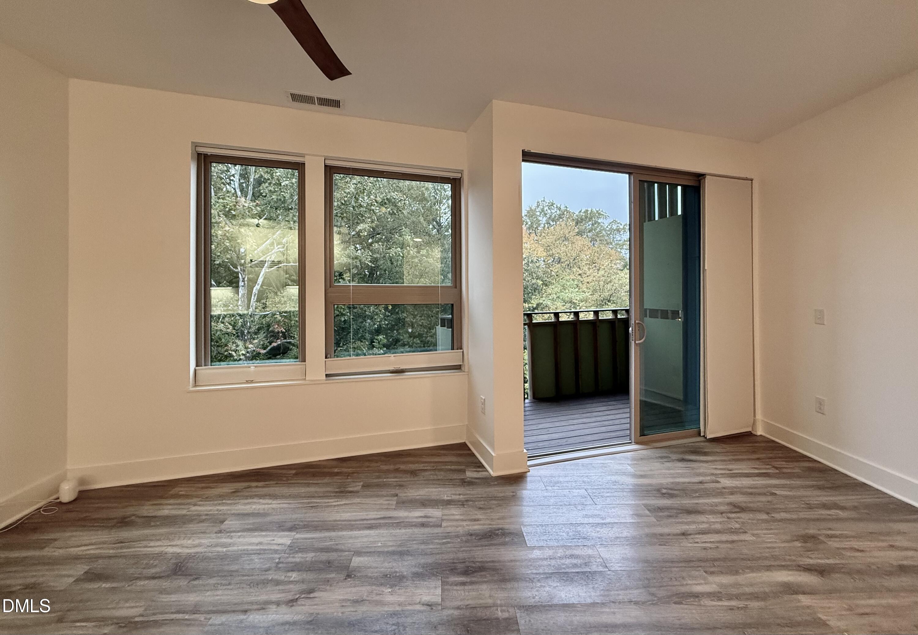 610 Trent Drive, Unit 403 Durham, NC 27705 - Photo 26 of 51 a view of a big room with wooden floor and windows