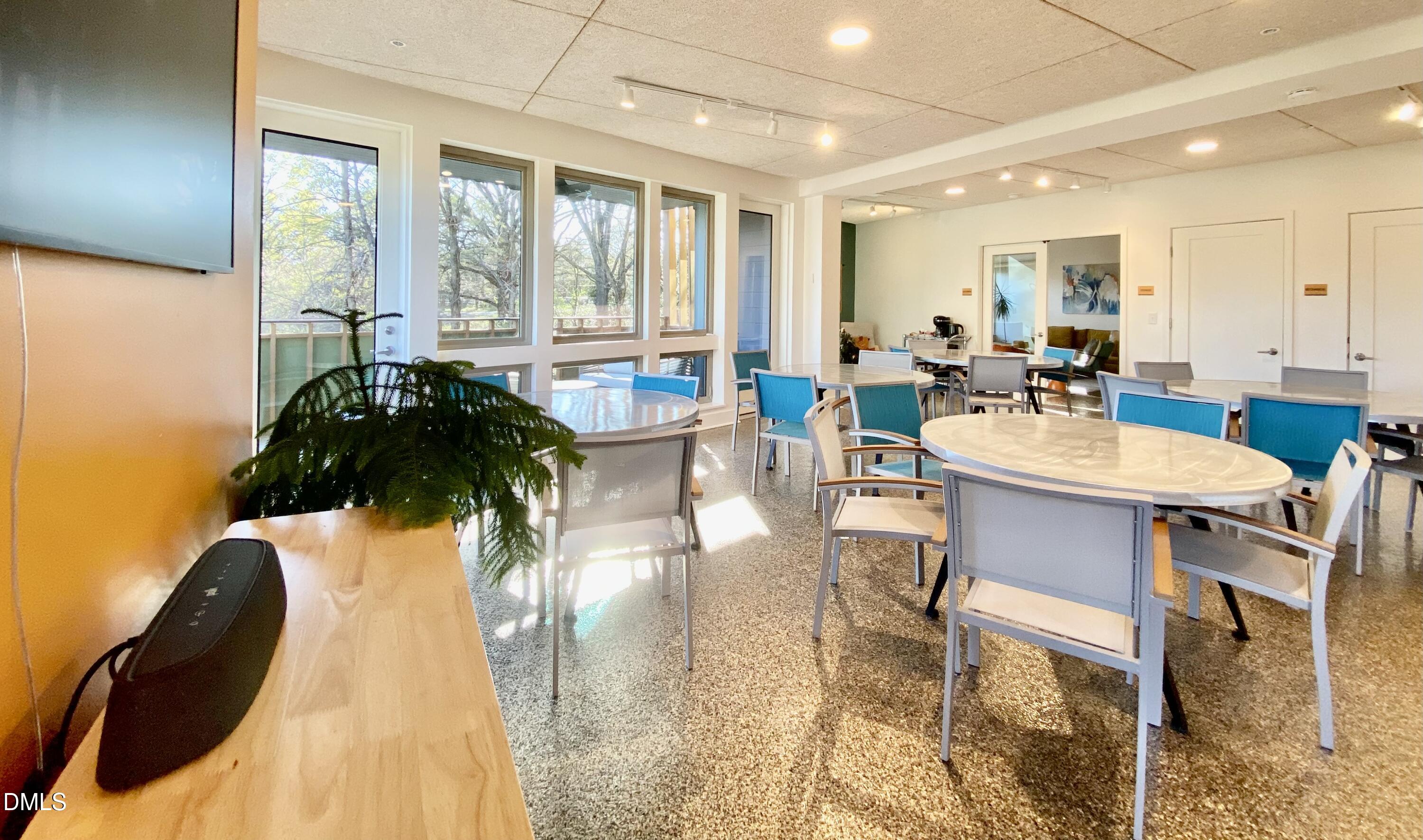 610 Trent Drive, Unit 403 Durham, NC 27705 - Photo 35 of 51 a dining room with furniture and wooden floor