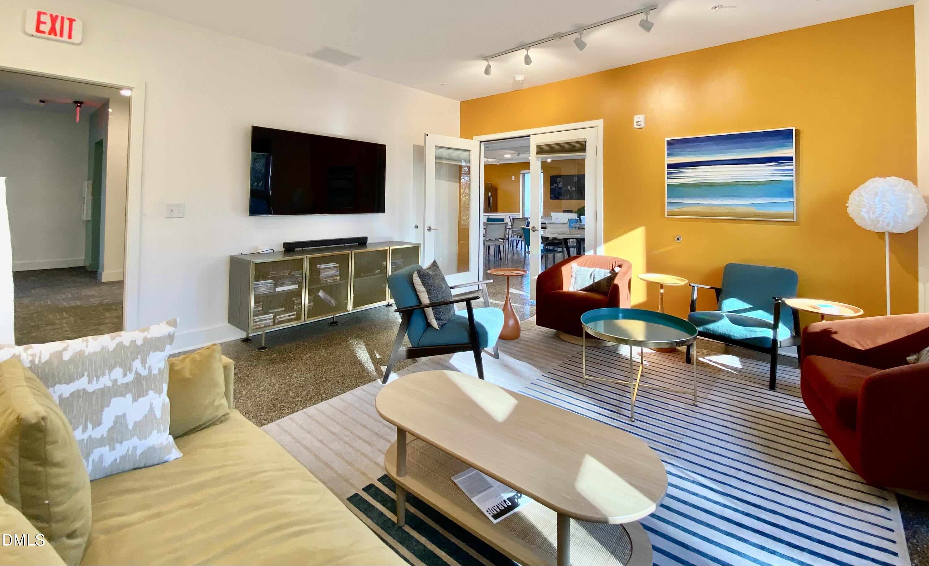 610 Trent Drive, Unit 403 Durham, NC 27705 - Photo 42 of 51 a living room with furniture and a flat screen tv