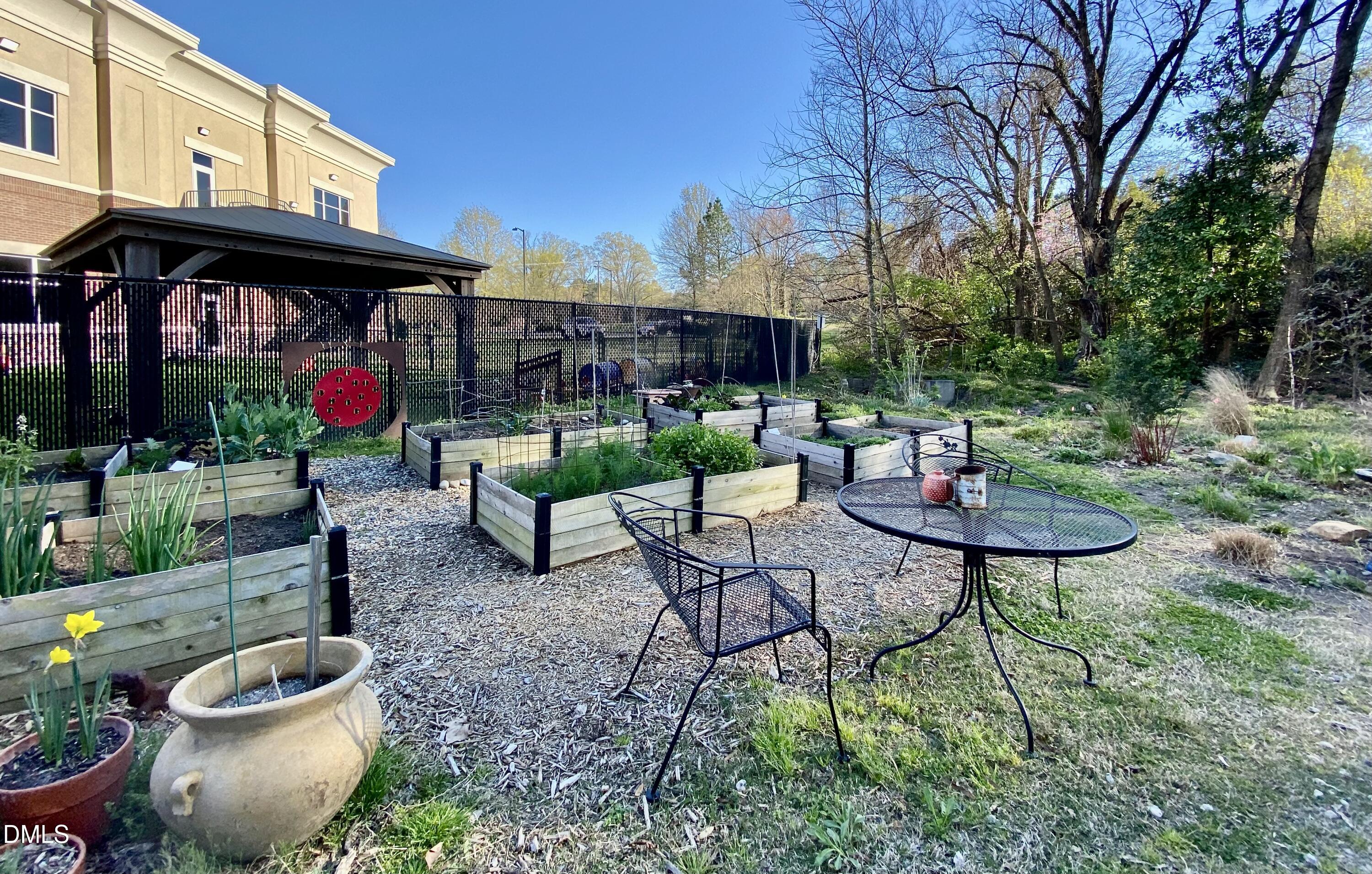 610 Trent Drive, Unit 403 Durham, NC 27705 - Photo 47 of 51 a view of a chairs and table in backyard