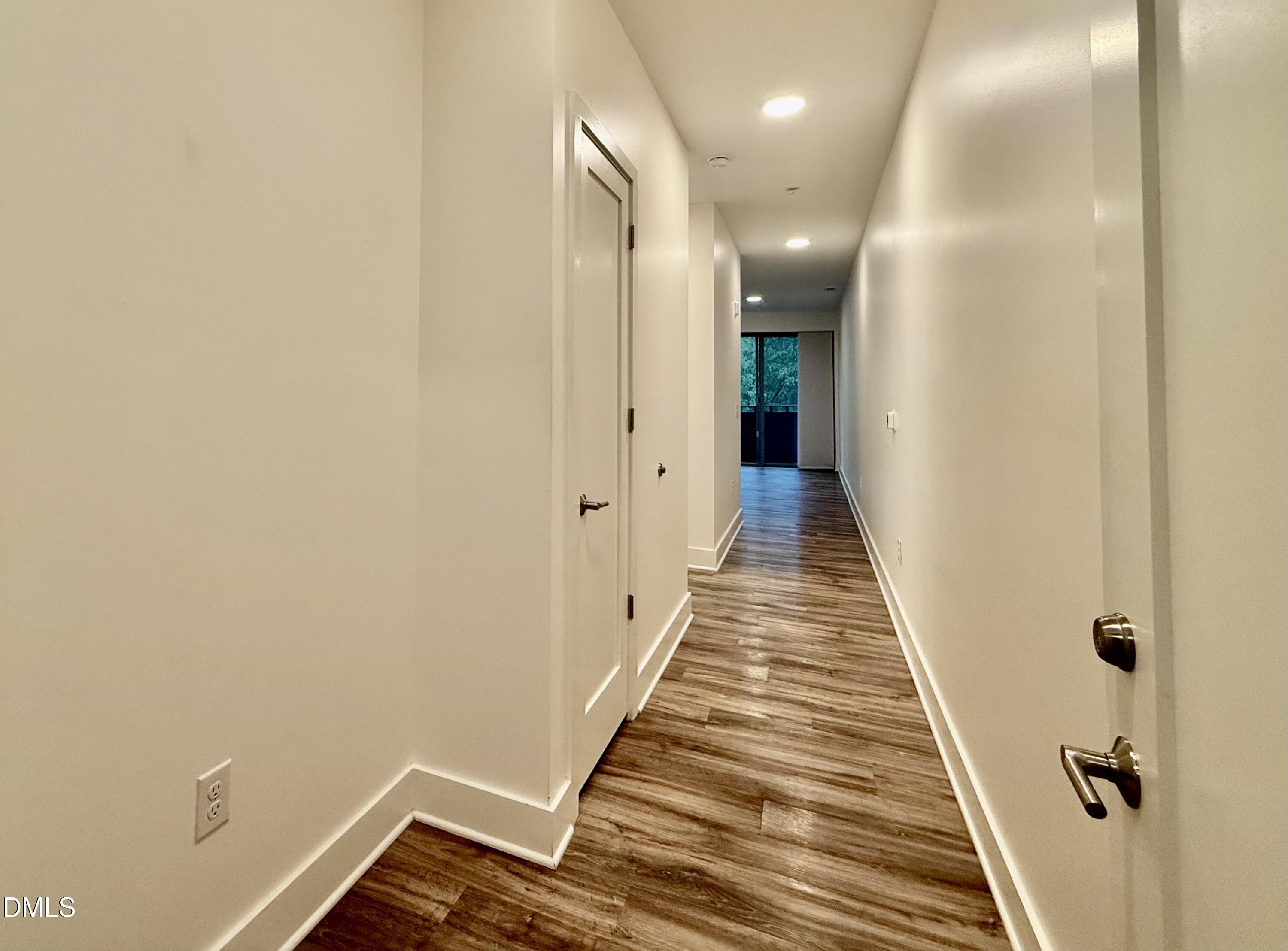 610 Trent Drive, Unit 403 Durham, NC 27705 - Photo 10 of 51 a view of a hallway with wooden floor and staircase