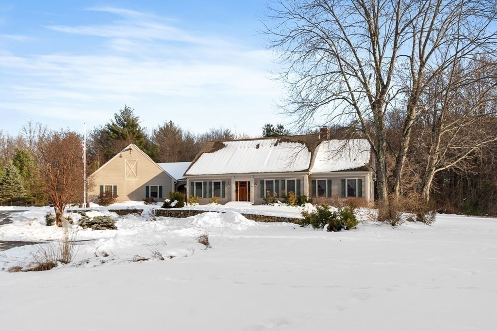 281 Taylor Road Stow, MA 01775 - Photo 2 of 42 a front view of a house with a yard covered in snow