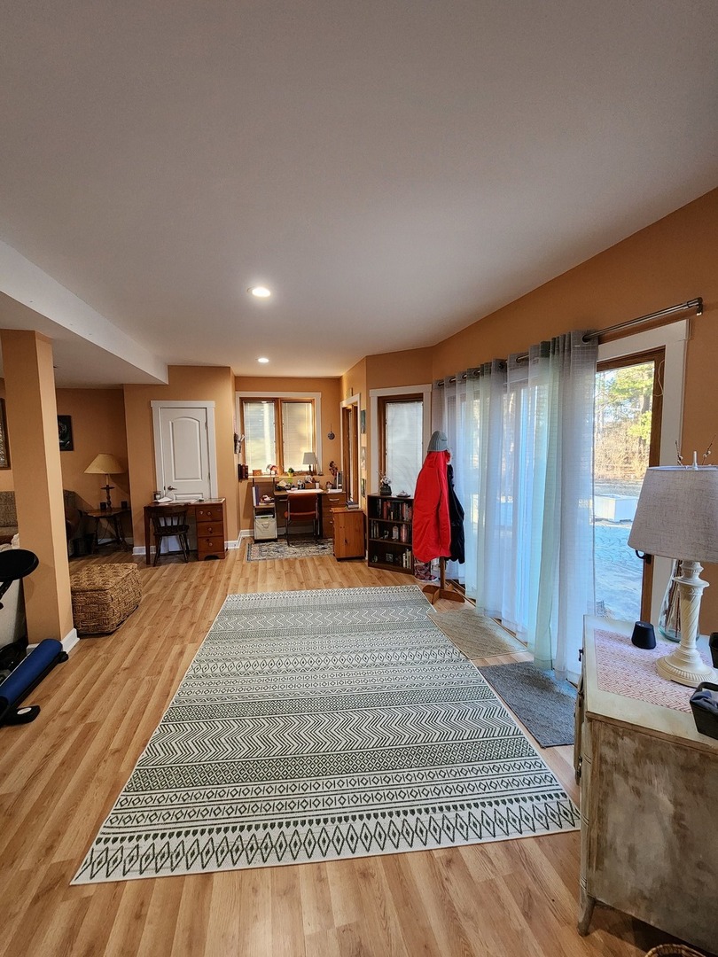 1504 Marshland Way, Unit BASMENT Bull Valley, IL 60098 - Photo 13 of 16 a living room with furniture and a wooden floor