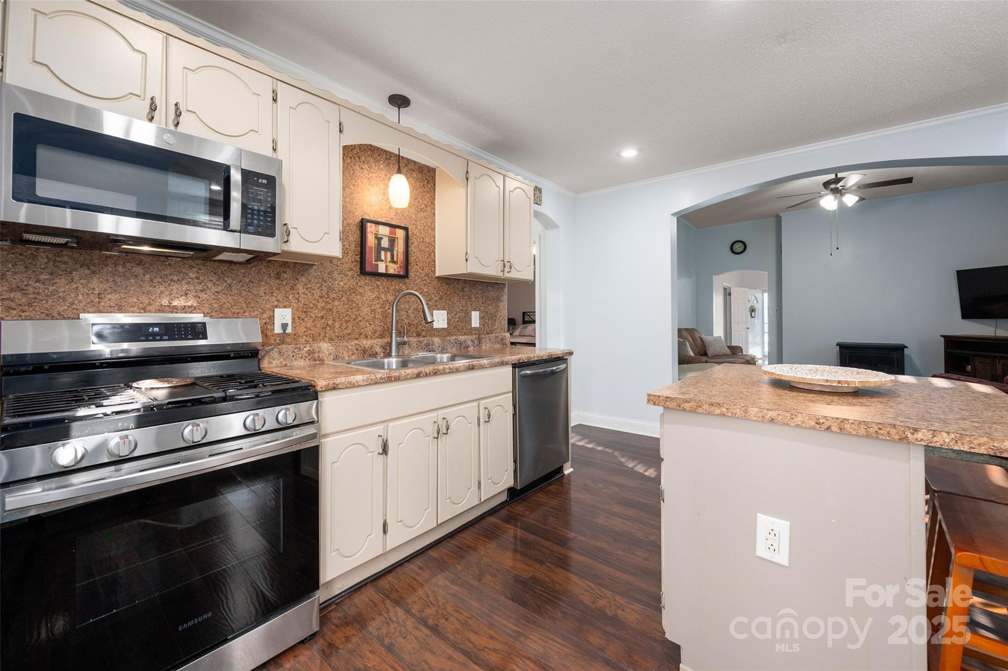 8 Cauthen Street Rock Hill, SC 29730 - Photo 19 of 36 a kitchen with stainless steel appliances granite countertop a stove top oven a sink dishwasher and a microwave oven with wooden floor