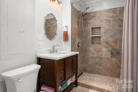 a bathroom with a sink toilet and shower