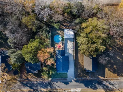 a front view of a house with a tree