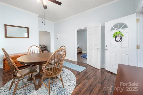a view of a a dining room with furniture window and wooden floor