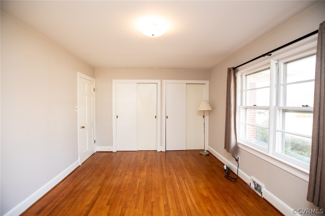 325 Fairgrounds Road Farmville, VA 23901 - Photo 23 of 40 an empty room with wooden floor and windows