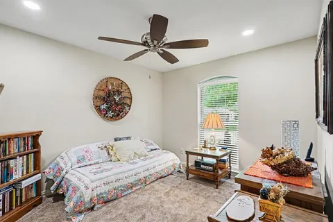 a bedroom with furniture and a book shelf