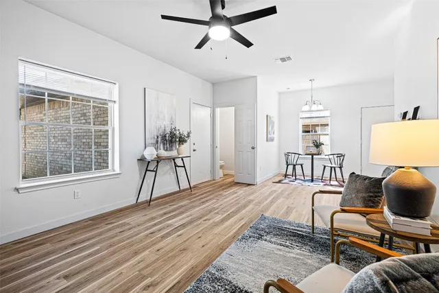 a living room with furniture and wooden floor