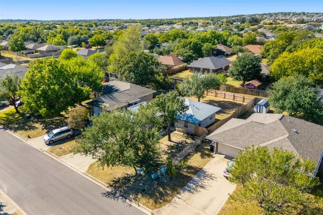 an aerial view of residential houses with outdoor space