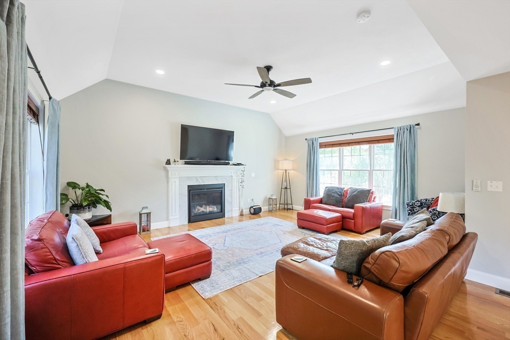 27 Paddock Circle Middleboro, MA 02346 - Photo 13 of 35 a living room with furniture a fireplace and a flat screen tv