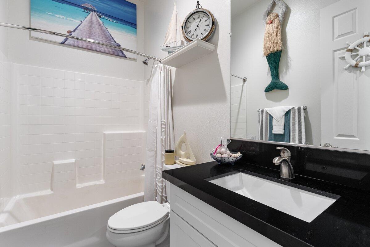 44027 Triolo Way Indio, CA 92203 - Photo 12 of 17 a bathroom with a sink a toilet and shower