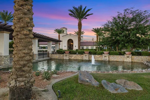 a view of a house with a yard from a fountain