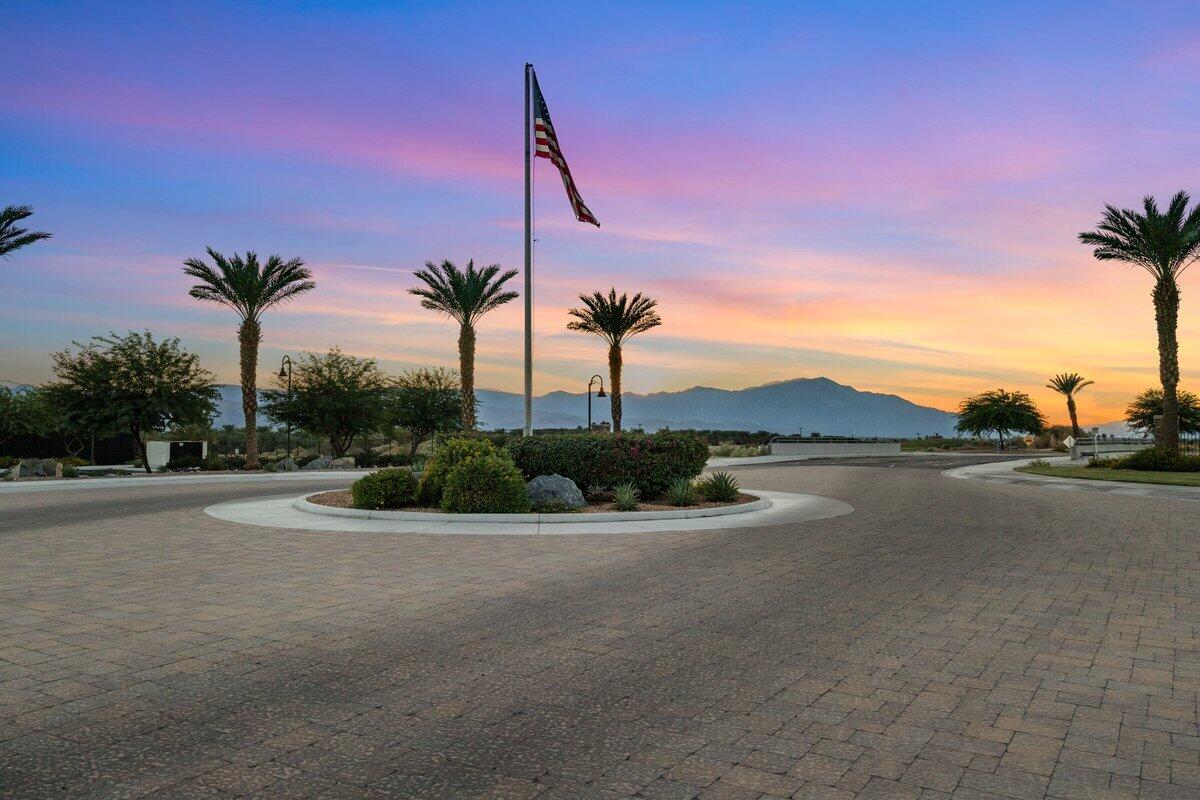 44027 Triolo Way Indio, CA 92203 - Photo 17 of 17 a view of a lake with a palm tree next to a road