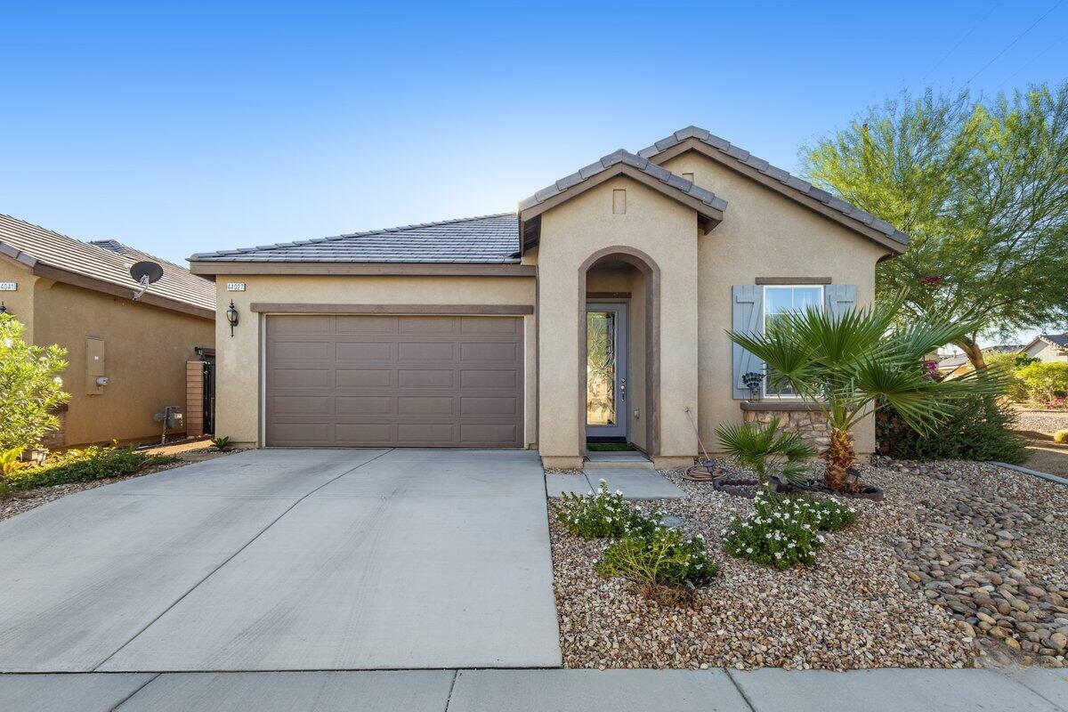 44027 Triolo Way Indio, CA 92203 - Photo 2 of 17 a view of a house with a yard