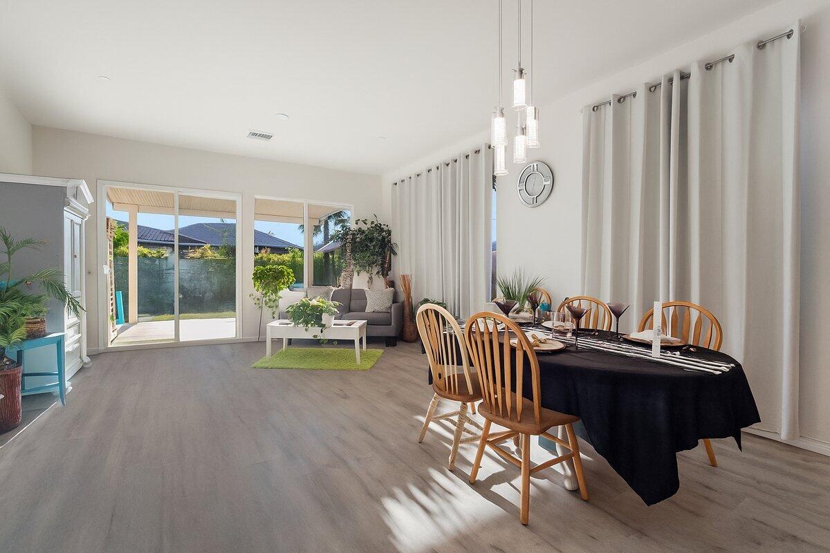44027 Triolo Way Indio, CA 92203 - Photo 3 of 17 a living room with furniture and a chandelier